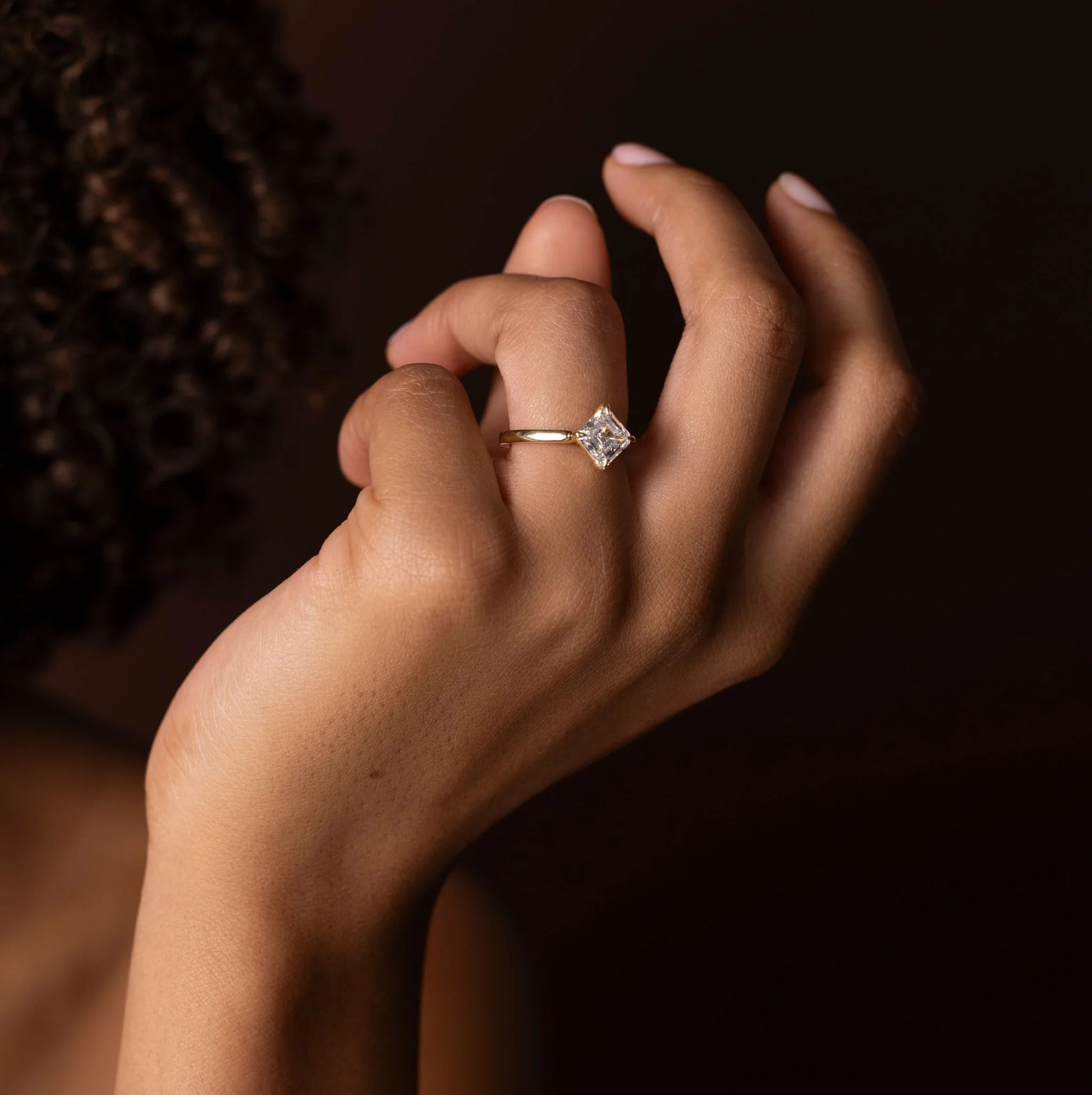 Hand model wearing a cushion ring